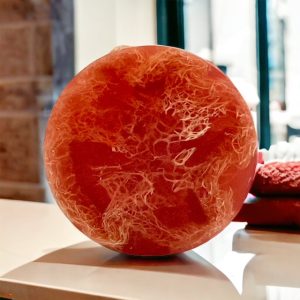 A red ball on top of a table.