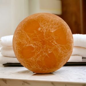 A round orange sitting on top of a table.