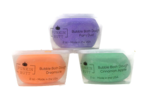 Three different colored soaps in a plastic container.