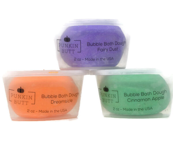 Three different colored soaps in a plastic container.